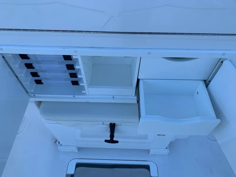 Slide: The Image of 2024 Invincible 33 Open Fisherman storage compartments and tackle boxes. - 14