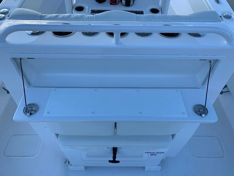 Slide: The Image of 2024 Invincible 33 Open Fisherman boat console with storage and seating. - 15