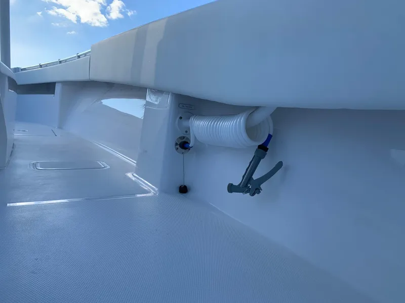 Slide: The Image of 2024 Invincible 33 Open Fisherman deck with hose and nozzle. - 18