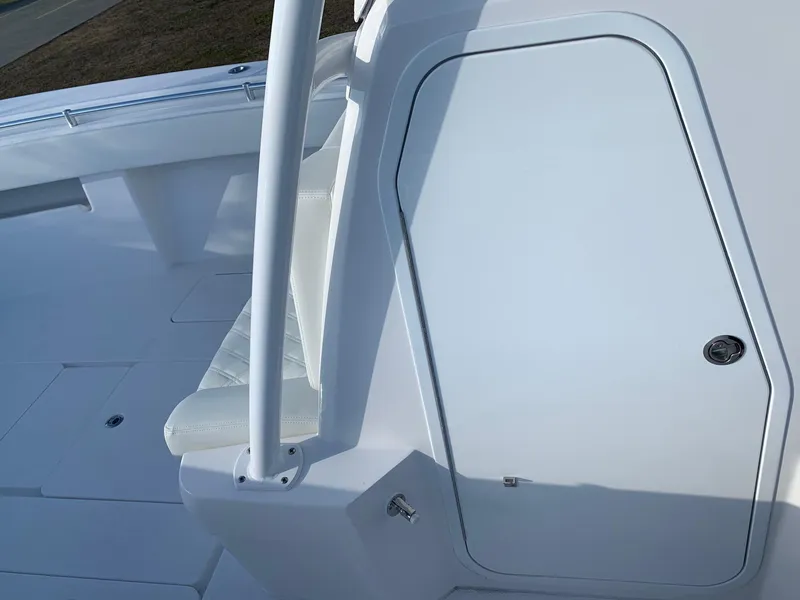 Slide: The Image of 2024 Invincible 33 Open Fisherman boat interior, featuring white seating and storage compartment. - 27