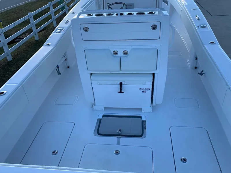 Slide: The Image of 2024 Invincible 33 Open Fisherman boat interior with storage compartments and cooler. - 5