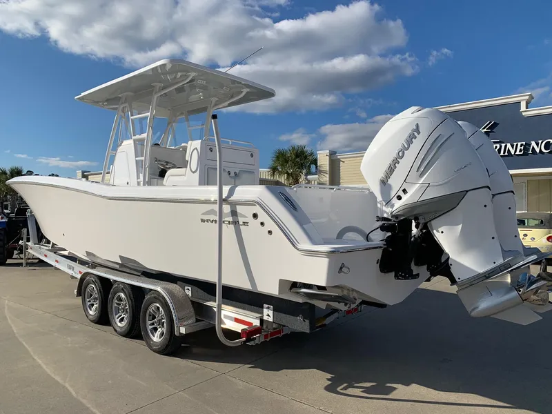 Slide: The Image of 2024 Invincible 33 Open Fisherman boat on a trailer with twin Mercury outboard engines. - 1