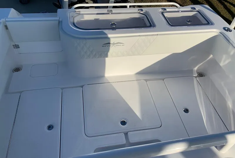 Slide: The Image of 2024 Invincible 33 Open Fisherman boat deck with storage compartments and livewells. - 11