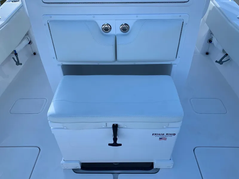 Slide: The Image of 2024 Invincible 33 Open Fisherman boat interior with storage and cooler. - 13