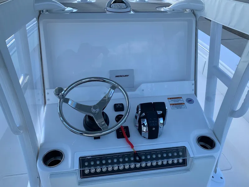 Slide: The Image of 2024 Invincible 33 Open Fisherman boat console with steering wheel and controls. - 21