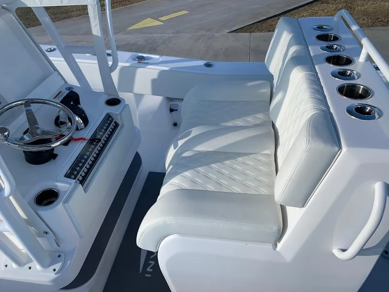 Slide: The Image of 2024 Invincible 33 Open Fisherman boat cockpit with white seating and steering console. - 24