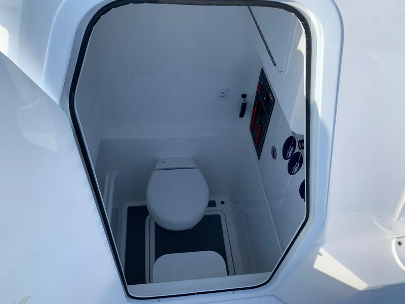 Slide: The Image of 2024 Invincible 33 Open Fisherman boat interior toilet compartment. - 26