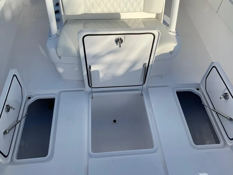 Slide: The Image of 2024 Invincible 33 Open Fisherman boat storage compartments and seating area. - 32