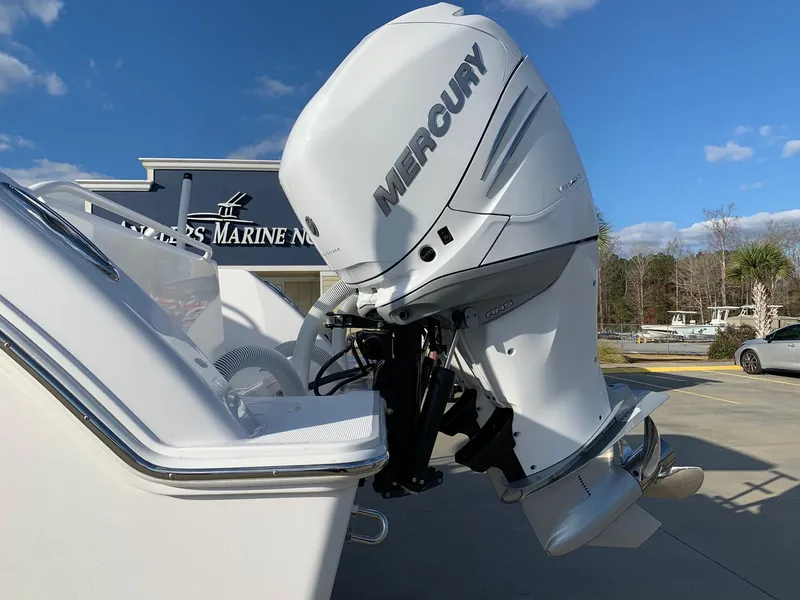 Slide: The Image of 2024 Invincible 33 Open Fisherman with Mercury outboard motor at a marine dealership. - 4