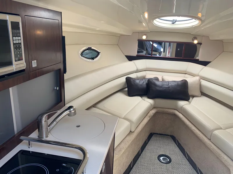 Slide: The Image of Interior of the 2015 Monterey 275 Sport Yacht with elegant seating area and kitchenette. - 45