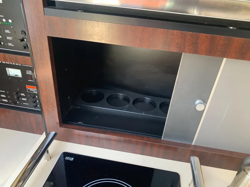 Slide: The Image of The galley of a 2015 Monterey 275 Sport Yacht with a stove and cabinet. - 40