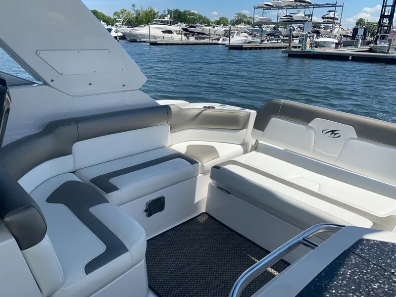 Slide: The Image of The image shows the cockpit of a 2015 Monterey 275 Sport Yacht with white and gray seating. - 28