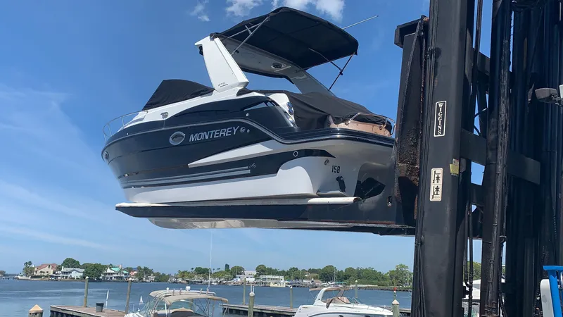 Slide: The Image of A 2015 Monterey 275 Sport Yacht is lifted by a crane above the water. - 46