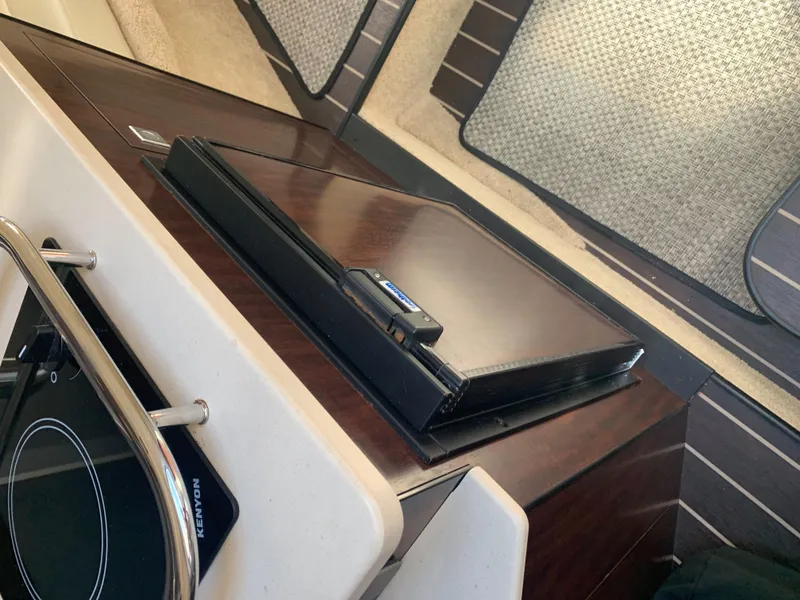 Slide: The Image of Interior of a 2015 Monterey 275 Sport Yacht with dark wood and modern details. - 44