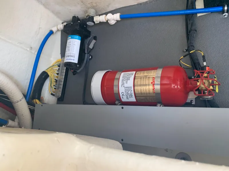 Slide: The Image of A fire extinguisher and water pump are mounted in a boat's engine compartment. - 30