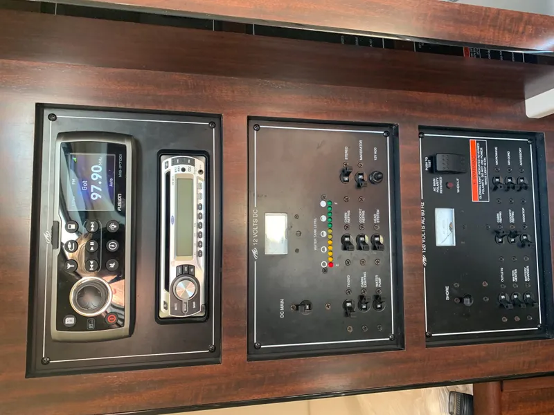 Slide: The Image of The image shows the dashboard of a 2015 Monterey 275 Sport Yacht with various controls and displays. - 14