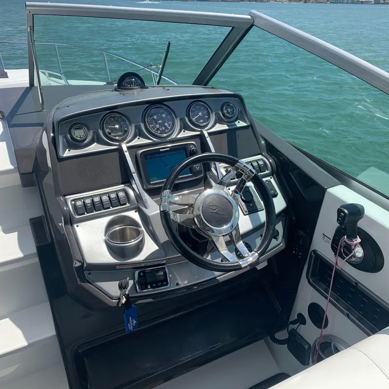 Slide: The Image of The cockpit of a 2015 Monterey 275 Sport Yacht with modern steering and instruments. - 24