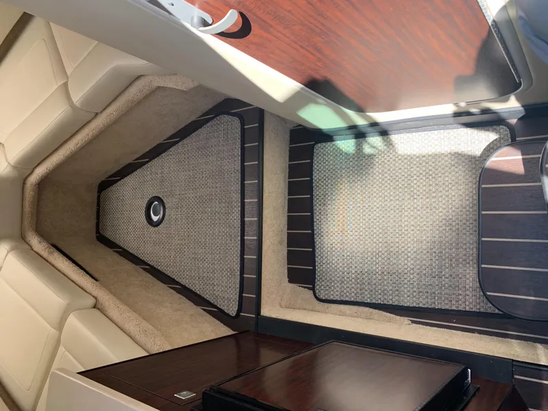 Slide: The Image of Interior of the 2015 Monterey 275 Sport Yacht with elegant carpeting and wood flooring. - 17