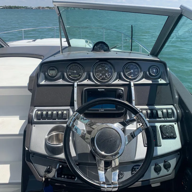 Slide: The Image of The image shows the helm of a 2015 Monterey 275 Sport Yacht with multiple instruments. - 6