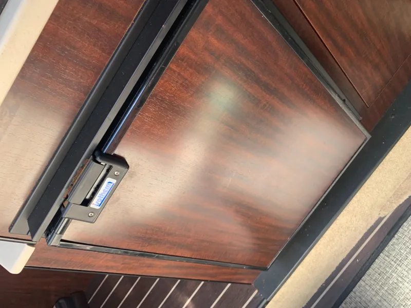 Slide: The Image of Wood-paneled refrigerator in a yacht cabin. - 38