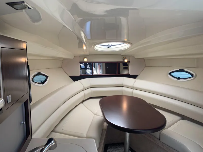 Slide: The Image of Interior of a 2015 Monterey 275 Sport Yacht with elegant seating area and table. - 34
