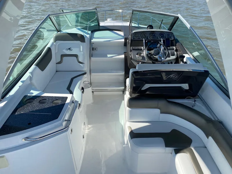 Slide: The Image of The image shows the cockpit of a 2015 Monterey 275 Sport Yacht with sleek seating and helm. - 3