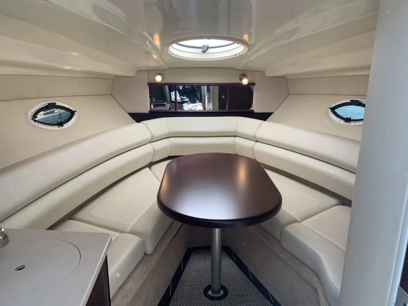 Slide: The Image of Interior of the 2015 Monterey 275 Sport Yacht featuring an elegant seating area and table. - 8