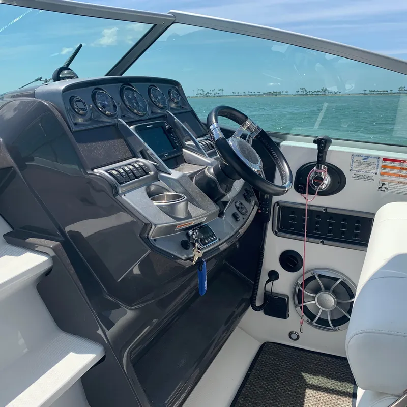 Slide: The Image of The image shows the helm of a 2015 Monterey 275 Sport Yacht with modern instruments. - 5