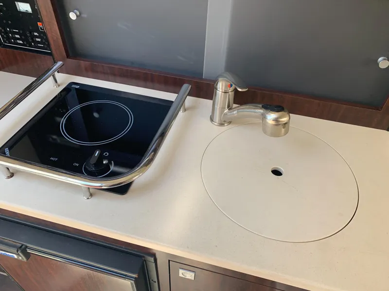 Slide: The Image of The galley of a 2015 Monterey 275 Sport Yacht with a stove and sink. - 42
