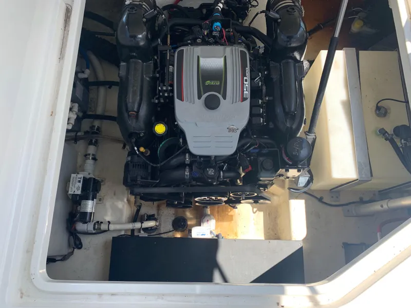 Slide: The Image of The engine compartment of a 2015 Monterey 275 Sport Yacht features a neatly installed engine. - 29
