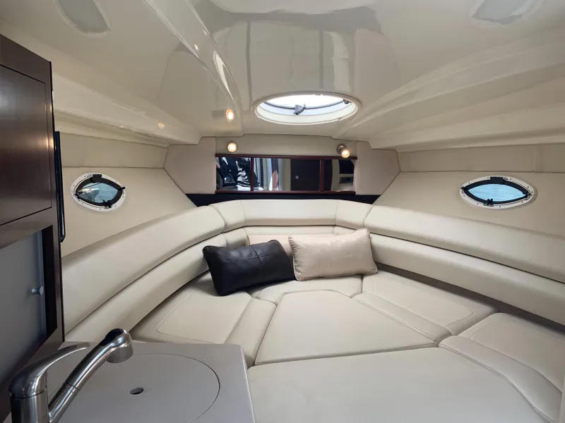 Slide: The Image of Interior of the 2015 Monterey 275 Sport Yacht with sleek upholstery and portholes. - 35