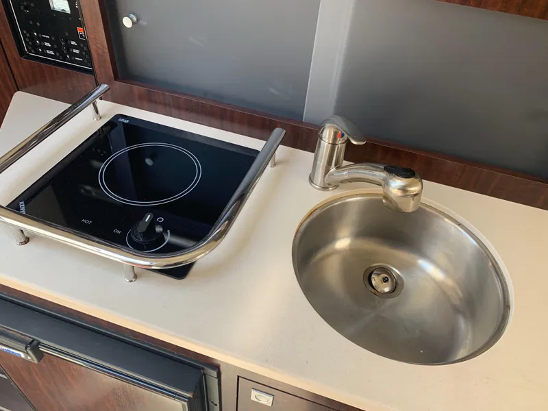 Slide: The Image of Galley with stove and sink in a 2015 Monterey 275 Sport Yacht. - 41