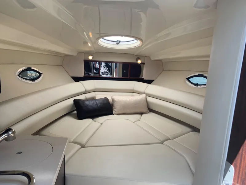 Slide: The Image of The 2015 Monterey 275 Sport Yacht cabin features a cozy seating area with cushions. - 9