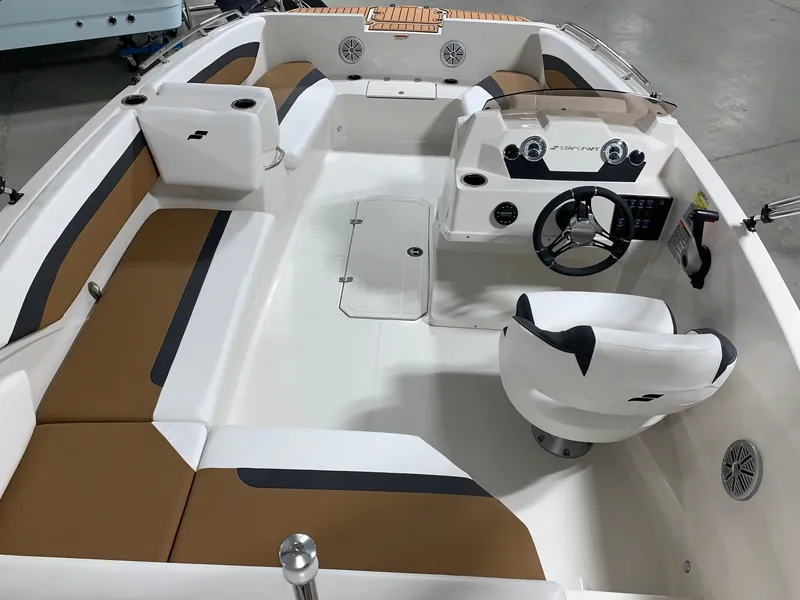 Slide: The Image of 2024 Starcraft SVX 171 boat interior with white and brown seating, steering console, and dashboard. - 15