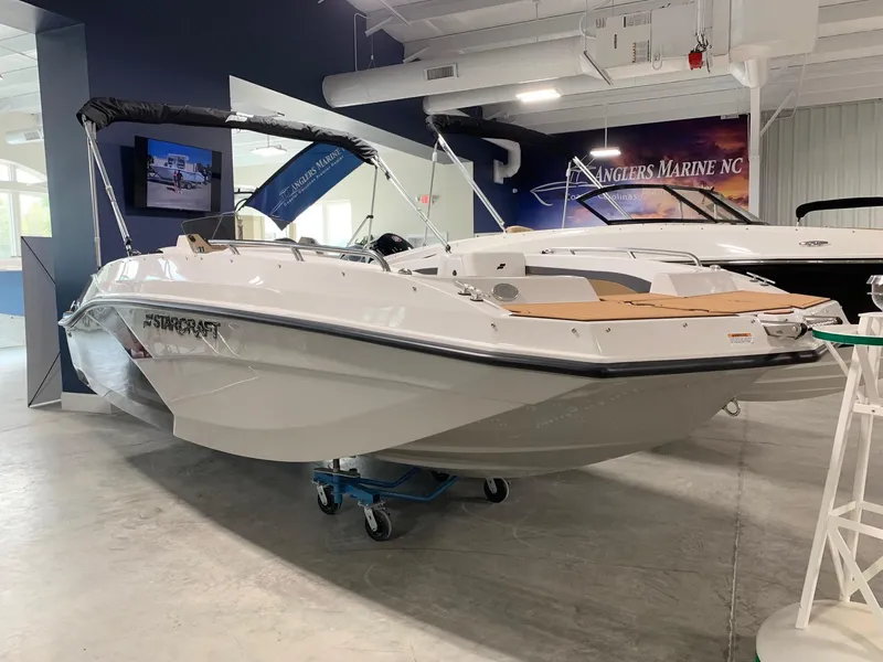 Slide: The Image of 2024 Starcraft SVX 171 boat displayed in a showroom. - 2