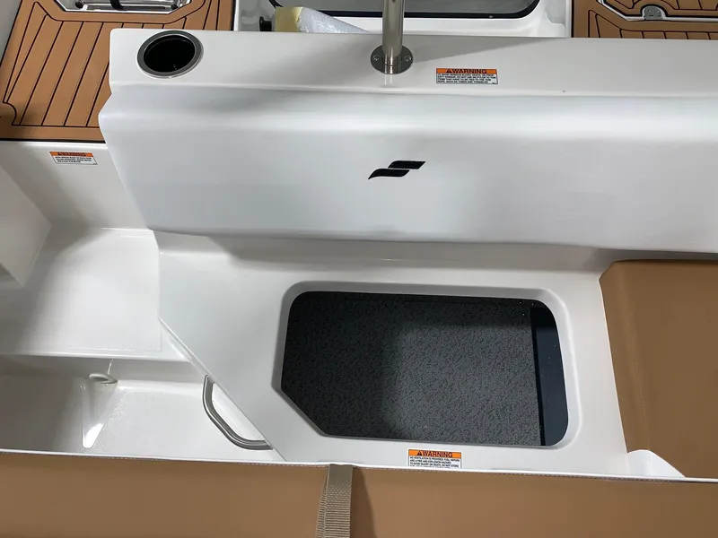Slide: The Image of 2024 Starcraft SVX 171 boat interior with storage compartment and cup holder. - 6
