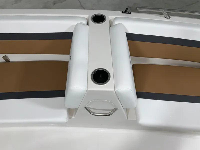 Slide: The Image of 2024 Starcraft SVX 171 boat interior with tan and white seating and cup holders. - 7