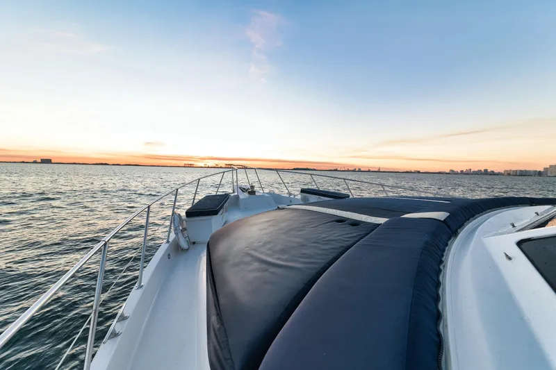 Slide: The Image of 2002 Hatteras Motor Yacht cruising at sunset on calm waters. - 19