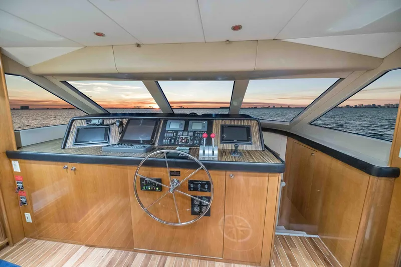 Slide: The Image of Helm of 2002 Hatteras Motor Yacht with panoramic windows and wooden dashboard. - 28