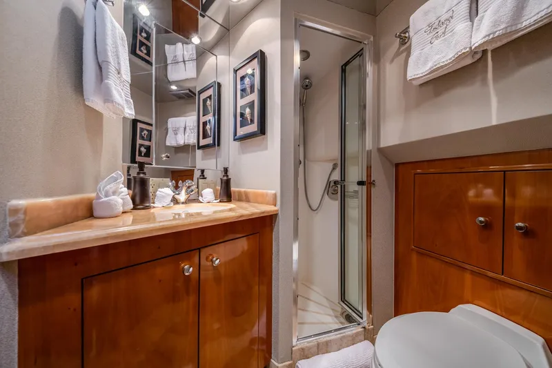 Slide: The Image of Luxurious bathroom in 2002 Hatteras Motor Yacht with wood cabinetry and glass shower. - 31