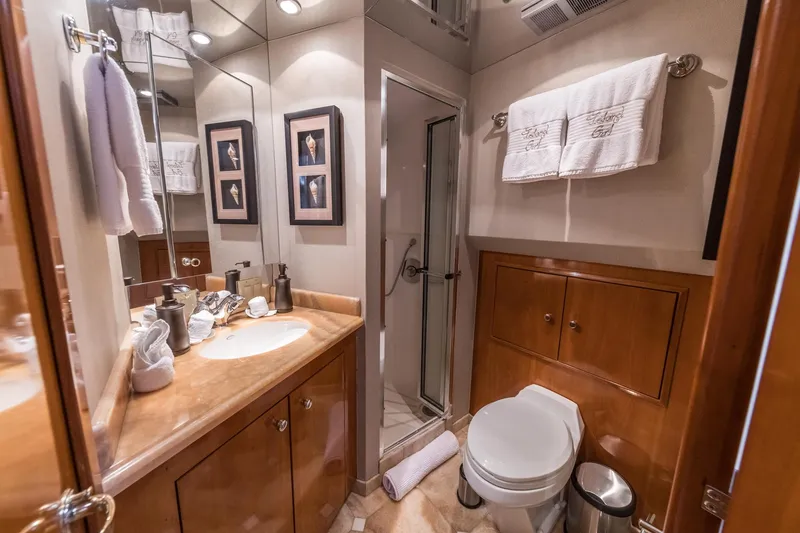 Slide: The Image of Luxurious bathroom in a 2002 Hatteras Motor Yacht with elegant wood cabinetry and modern fixtures. - 35