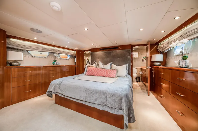 Slide: The Image of Luxurious bedroom interior of 2002 Hatteras Motor Yacht with elegant wood cabinetry and soft lighting. - 37