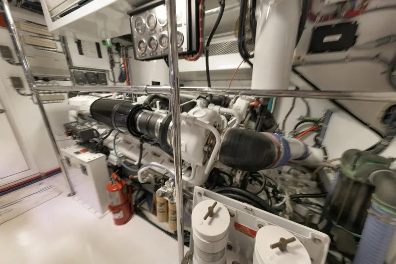 Slide: The Image of Engine room of a 2002 Hatteras Motor Yacht, featuring complex machinery and equipment. - 44