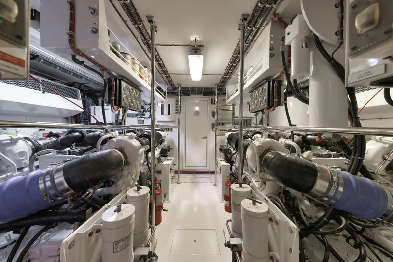 Slide: The Image of Engine room of a 2002 Hatteras Motor Yacht, showcasing dual engines and mechanical systems. - 45