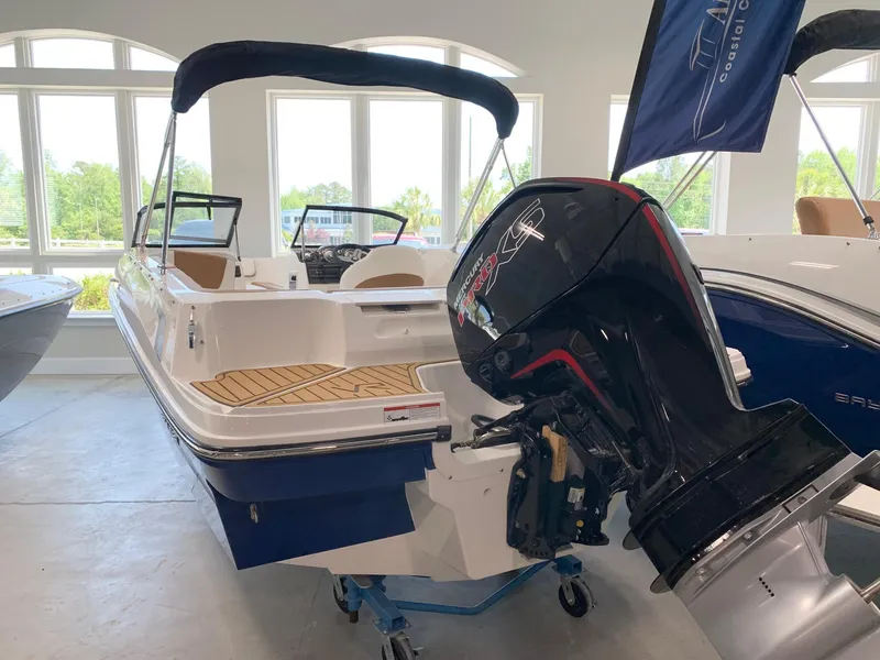 Slide: The Image of 2024 Bayliner VR4 boat with outboard motor in showroom. - 1