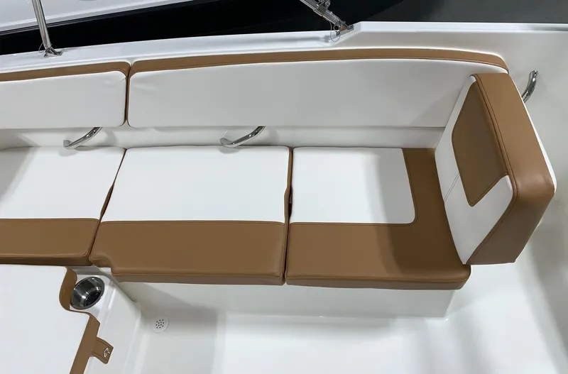 Slide: The Image of 2024 Bayliner VR4 boat interior seating with white and brown cushions. - 12