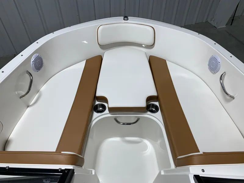 Slide: The Image of 2024 Bayliner VR4 boat interior with tan and white seating. - 17