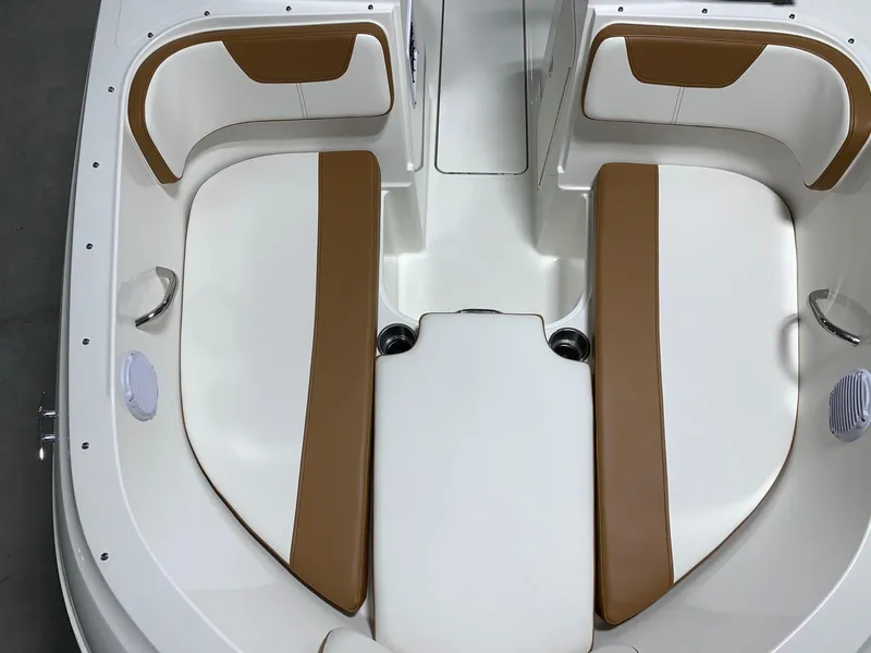 Slide: The Image of 2024 Bayliner VR4 boat interior with white and brown seating. - 18