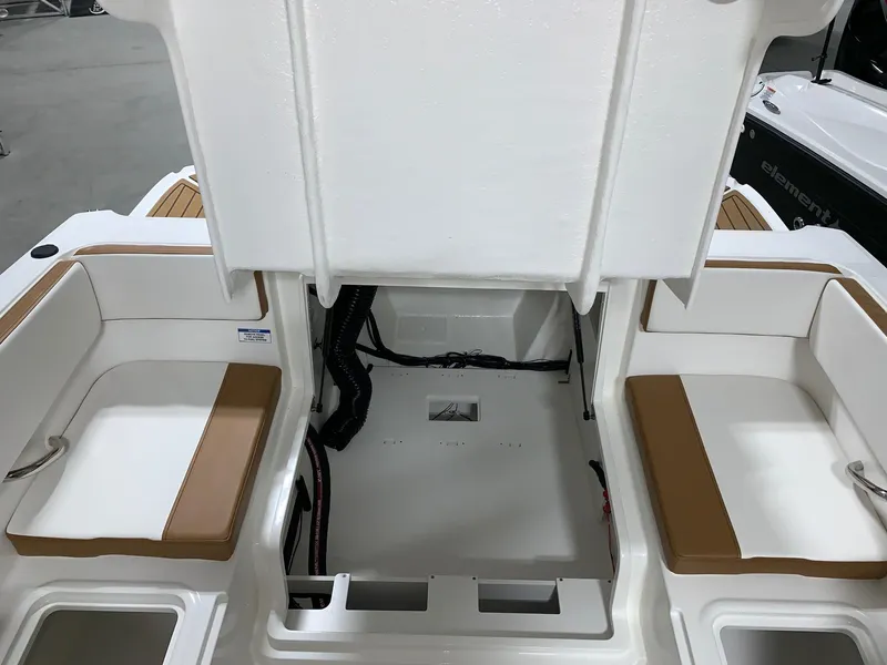 Slide: The Image of 2024 Bayliner VR4 boat interior with open storage compartment and cushioned seating. - 19
