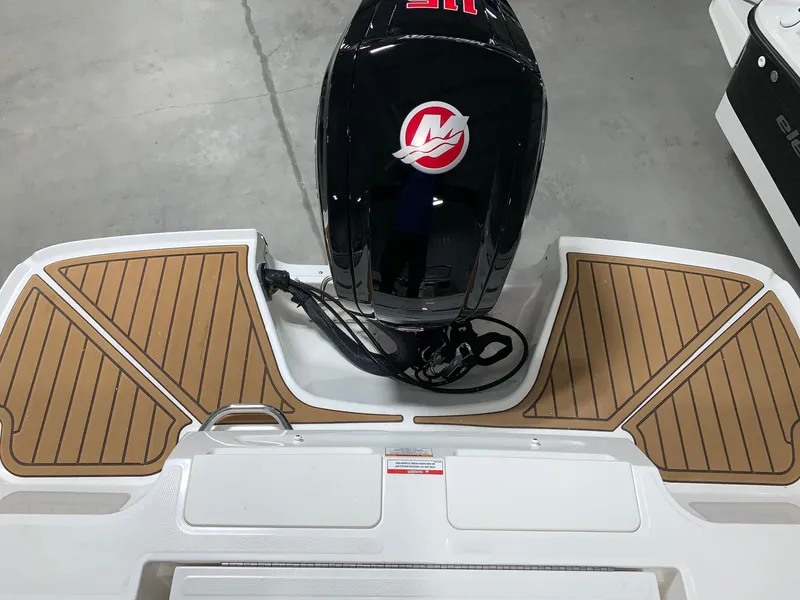 Slide: The Image of 2024 Bayliner VR4 boat stern with outboard motor and teak-style decking. - 7
